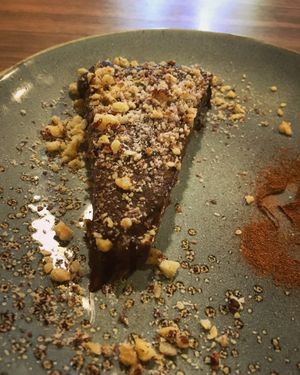 Cake Raw Ganache de Cacau base de tâmaras, castanhas e Farofa de Avelã  at Raw Porto Alegre in Porto Alegre