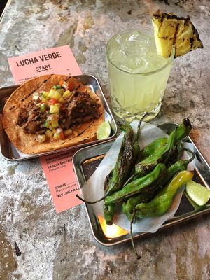 Limo Wreck (mezcal) cocktail, Pasillo BBQ Jackfruit taco, blistered shisho peppers. at Lucha Verde in Vancouver