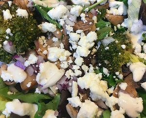 Feel the Vibe! local mix, white beans, mushrooms, roasted broccoli topped with red onions, feta crumblers with feta dressing at Local Vibe Cafe in Petersburg