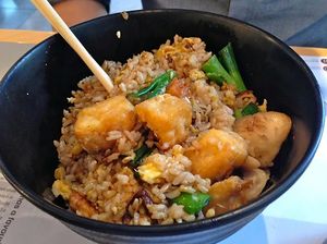yasai cha han donburi – stir-fried brown rice with tofu and vegetables, egg, mushrooms, mangetout, sweetcorn and spring onions, served with a side of japanese pickles. at Wagamama in Dartford