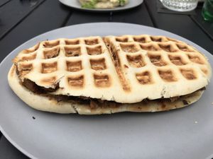 Bulky Bill waffle sandwich. Waffle filled with gyros, mushrooms, vegan cheese, grilled onions, potatoes, and bbq sauce. at V-Box in Ghent