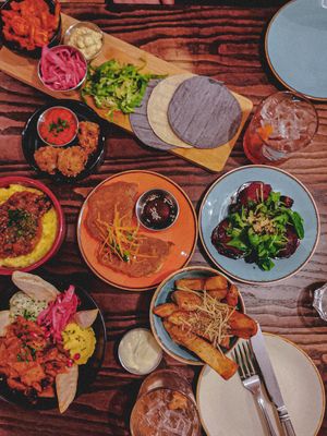 Selection of small plates including cauliflower tacos, artichoke arancini, mushroom ragu with polenta, beetroot ravioli, kimchi pancakes, herb & parm chips and celeriac shawarma at The Tipsy Vegan in Cambridge