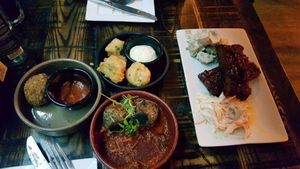 Half eaten - jalapeno poppers at the top, arancini left, meatballs bottom and full rack of ribs at The Tipsy Vegan in Cambridge