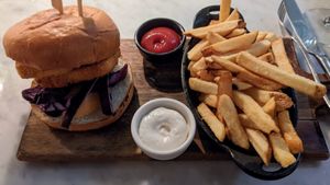 Poorly assembled tofu burger with massive chunks of raw red cabbage and undercooked cold fries at LOV - Montagne in Montreal