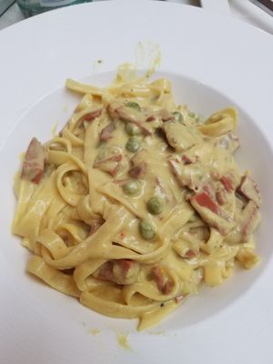 Fettuccine covered with vegan carbonara sauce and peas and veg bacon at Leona & 3 Brothers in Lynbrook