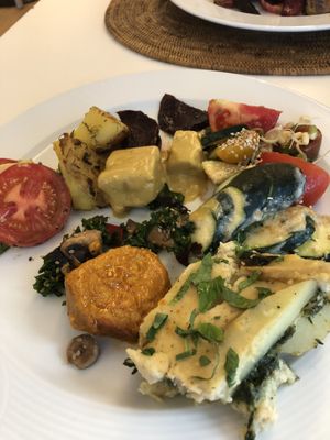 Delicious plate of hot foods and salads at The Sacred in Zurich