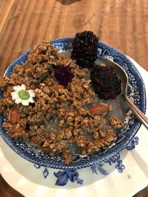Granola with edible flowers and soy milk at The Harbinger Cafe & Bakery in Charleston