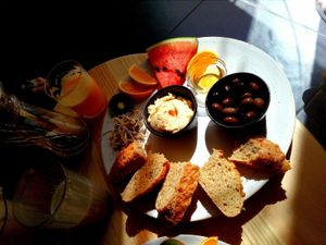 bread, hummus, olives, fruit, agave syrup at Goldig in Lagos