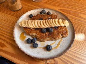 Pancakes 🥞 with blueberries 🫐 , bananas 🍌 and agave syrup   at Goldig in Lagos