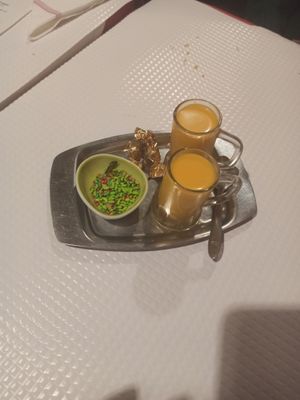 Mango lassi they serve after the meal, when you order the bill. Very tasty, made with coconut milk. The bowl on the side is filled with some kind of candy, made with spices.
 at Sanskar Nepal in Lisbon