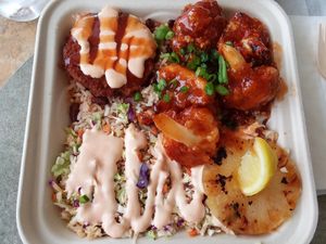 Build-a-bowl with sweet & sour cauliflower, vegan chicken, rice & beans, rainbow slaw at Dajen Eats in Eatonville