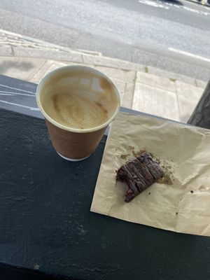 Coffee on the go! Oat Latte and a vegan brownie.   at My Village Hawraman Cafe in North West London