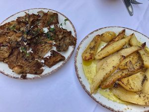 Potatoes swimming in oil. Mushrooms were ok though. at Candouni in Santorini