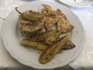Potatoes, pita bread, and some sort of off the menu dish with couscous, split peas, and peppers. 😋 at Candouni in Santorini