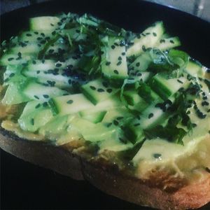 Avocado and cucumber on toast with miso and black sesame seeds at GLAM Vegan in Miami