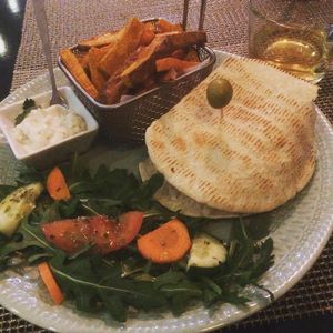 Hamburguer 100%vegan, with sweet potato, salad and garlic and herbs sauce. at Ohana By Naz in Lisbon