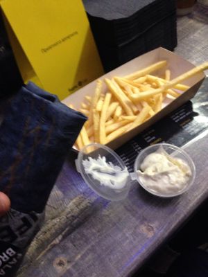 Falafel in black wrap, French fries and garlic sauce at Falafel Bro - Oruzheynyy in Moscow