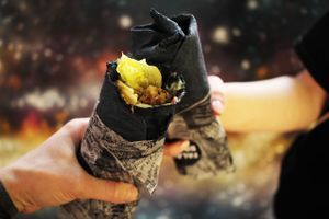 Sharing wrapped falafel with friends at Falafel Bro - Oruzheynyy in Moscow