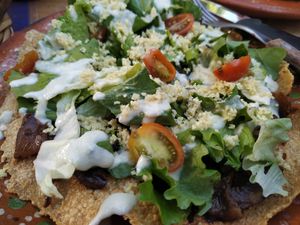 Tostada with... I forgot😄Something and red mole  at Casa Cacau in Ajijic
