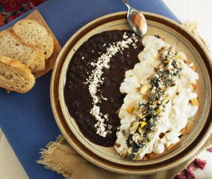 Chilaquiles Yin Yang 
Bañados en una salsa cremosa Vegana con un Topping de Huitlacoche, acompañados de frijoles negros refritos y pan.  at Casa Cacau in Ajijic
