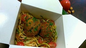Zucchini spaghetti and almond ";NOT"; meatballs in a live marinara sauce.
#rawvegan #notmeat #paperbox #ecofriendlytreats at Nuturi in Snellville