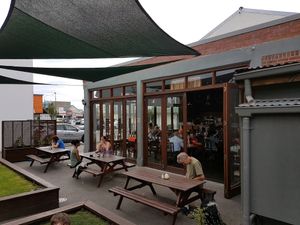 Outdoor seating with grassy spots at Addington Coffee Co-op in Christchurch