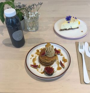 Amazing pancakes (but very small), black latte & lemon & ginger raw cheesecake at Alive in Geneva