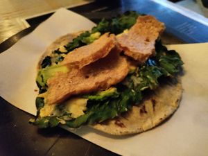 Chicharrón on top of a fried leaf taco at Malportaco in Mexico City