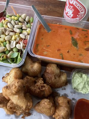 Best food I’ve eaten in Hua Hin! Som tam, tom yum soup and spicy red curry cauliflower wings 5/5. Ordered via Foodpanda.   at Hua Hin Vegan Cafe and Wine in Hua Hin