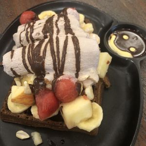 Waffles with fruit and ice cream, plus smiley face! at Justbe by Nidhi Nahata in Bangalore