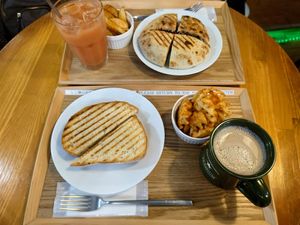 Top: pita sandwich, pressed with fries and guava juice. Bottom: German sauerkraut, vegan ham and pickles sandwich with mesh fries and chai latte at Falafel Brothers - Minato in Tokyo