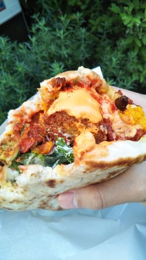 Completely forgot to take a photo before taking a bite! That's how good it was (toppings - tomato & cucumber, spicy peppers and pumpkin cabocha cha cha cha w/ spicy hini sauce) at Falafel Brothers - Minato in Tokyo