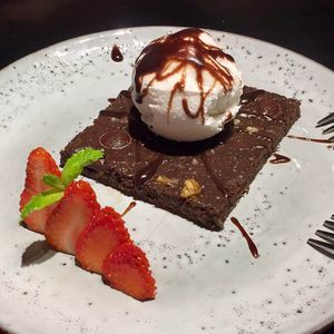 Chocolate brownie with coconut ice cream  at Tribe Organic in Shanghai