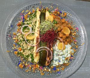 Roasted zucchini with spices and hot tabbouleh of bulgur - homemade tzatziki and stewed with onions, figs and chickpeas - almond, cumin and orange toping  at MU-Food in Geneva