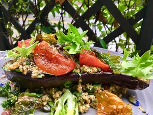 aubergine farcie au boulgour, menthe, coriandre, oignons raisins secs, amandes, tomates confites at MU-Food in Geneva