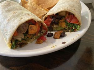 Burrito contained black beans, onion, red pepper, sweet potato, and kale. Added avocado.  at The Hoot in Northport