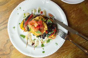 Mushroom on Sourdough   
Marinated grilled mushrooms, scrambled vegan eggs or poached eggs, turmeric hummus, roasted pepper, garlic sauce and balsamic dressing. at Miranda Cafe in North London