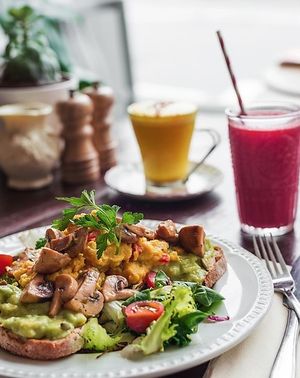 Beautiful Mornings deserve a beautiful breakfast! How about scrambled vegan eggs and grilled mushrooms on a bed of smashed avocado. Served with a coconut turmeric latte and a beetroot, carrot and orange juice.   at Miranda Cafe in North London