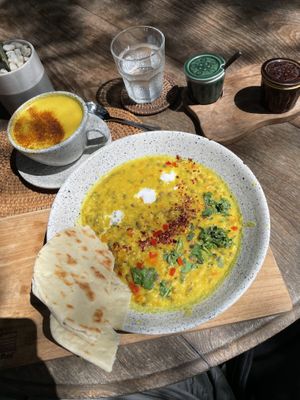 A local vegan breakfast savory porridge. It hit the spot. Also golden milk with coconut milk.   at Drifter Surf Shop & Cafe in Pecatu