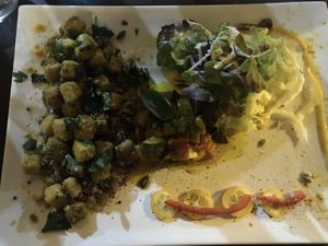 Stirred tofu with truffle oil, served with cooked mixed grain, ratatouille and salad at A Casa Leca in Ajaccio