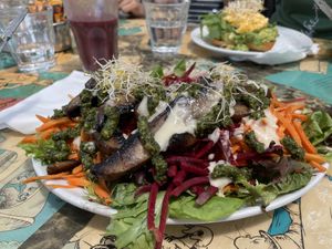 Mushroom pesto salad and açai smoothie. (Smashed Avo on toast with egg in background)  at Scallywags Cafe in Magnetic Island