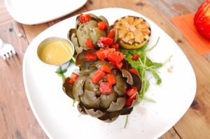 Artichoke with Sage Oil, Roasted Red Peppers, Burnt Lemon, and Coconut Curry Sauce at Garden Kitchen in San Diego