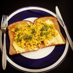 Tofu scramble on toast with a sprinkling of fresh basil from the garden.  at The Cosy Vegan in Dunfermline