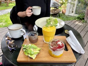 Vegan lunch: mango smoothie, avocado toast, chia seed pudding, and a chocolate mousse. My drink was a special coconut coffee they make.  at Spiregarden in Kristiansand