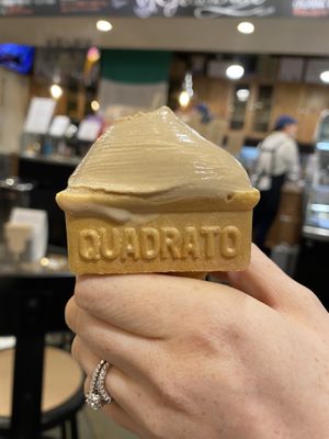 A half eaten Brown Sugar and Kinako vegan ice cream in waffle cone at Premarché Gelateria in Kyoto