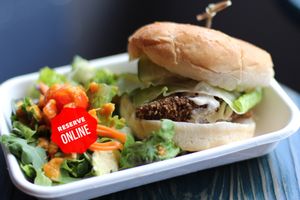 Spicy vegan chicken sandwich served with Yuzut pickled cumber tomatoes lettuce and vegan dressing at Pow Pow - H St NE in Washington