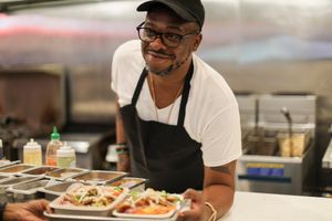 Jarobi White serving Yoga Dragons! 
Mock fried chicken tossed in peanut sauce w/black beans, edamame, bean sprouts & carrots w/sriracha nut crumbles, cucumber-lime & sriracha drizzle. (Vegan/Spicy/Contains Nuts at Pow Pow - H St NE in Washington