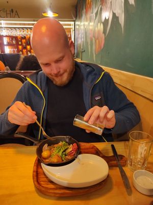 My boyfriend happy eating saltado at Chia Vegan Restaurant in Cusco