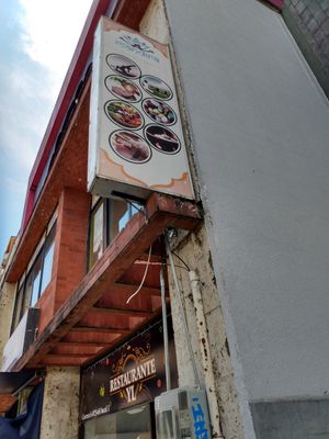 Exterior sign mounted to building at Mandira in Pereira