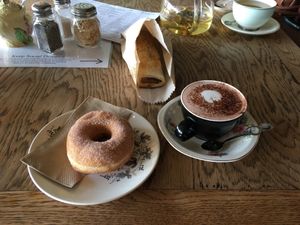 I got a donut, a sausie roll, and a hot choc with oat milk. at Portershed in Christchurch